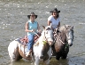 Leslie & Kris sitting on their horses in the Clarion River in PA.